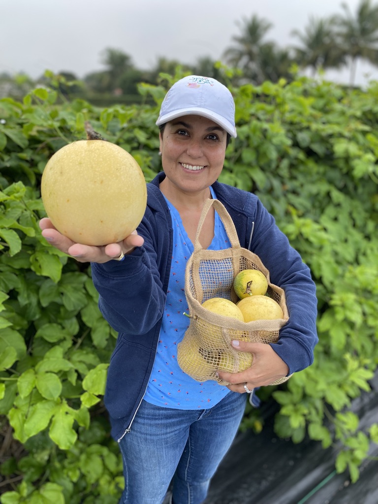 Catalina holding a fresh harvest at the farm
